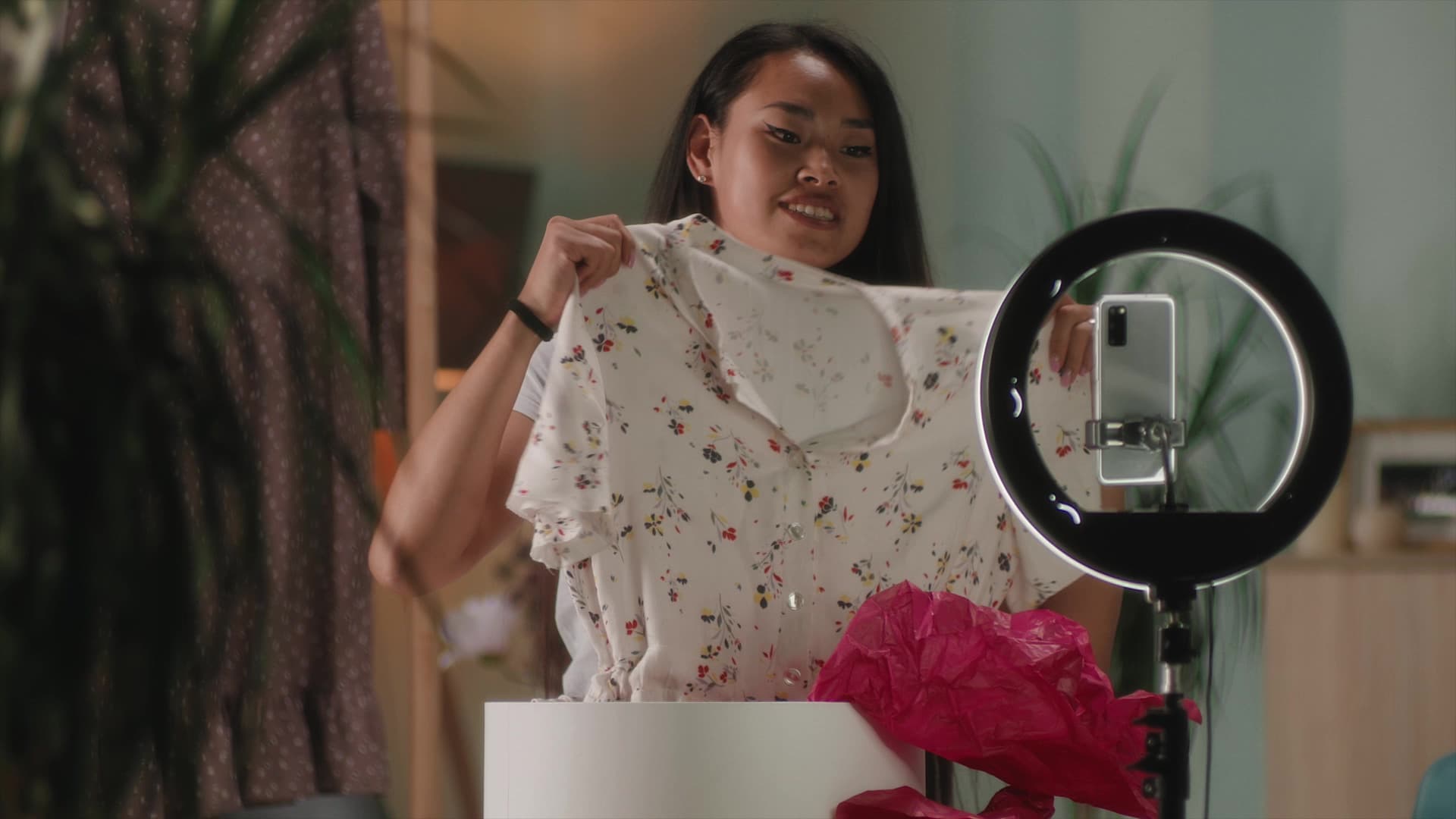 A girl recording a clothing haul with her mobile