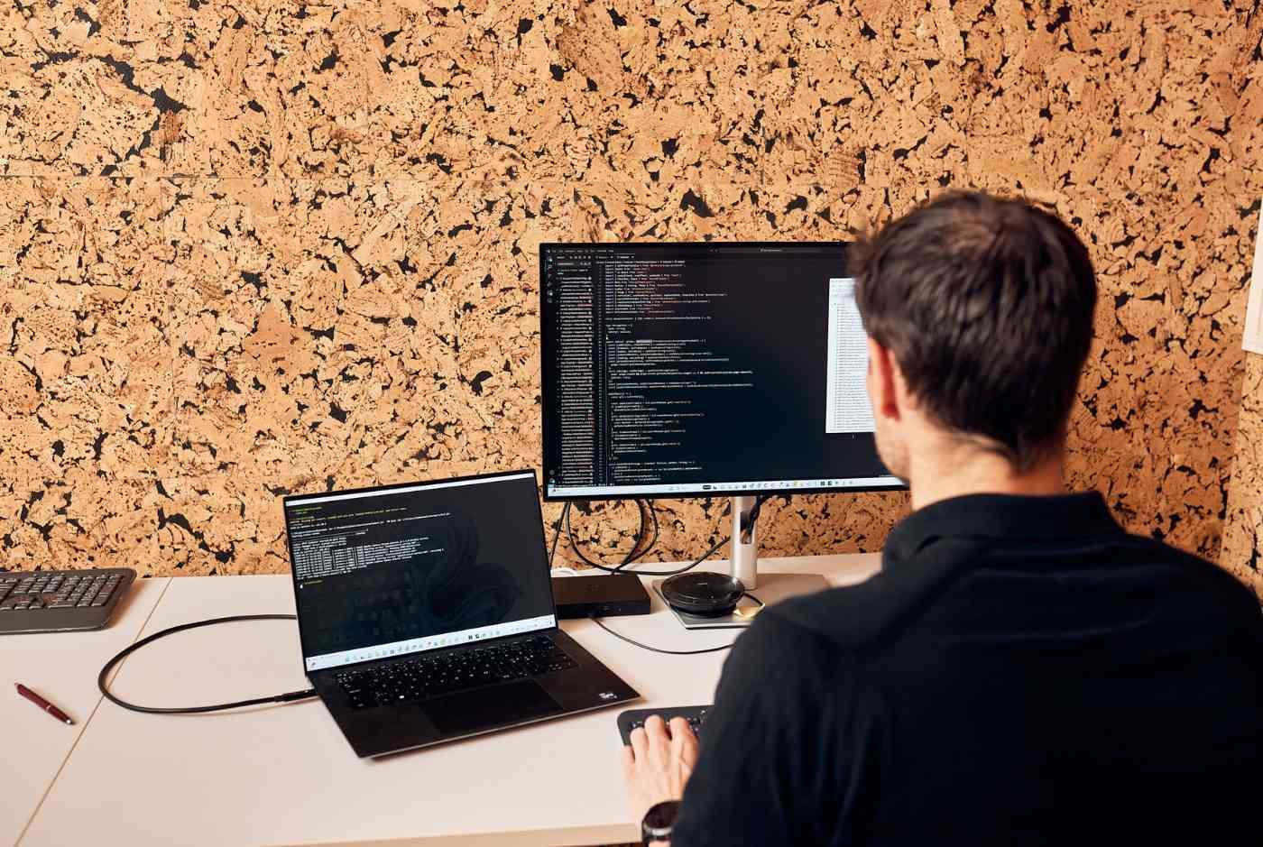 A web developer sitting by the desk working