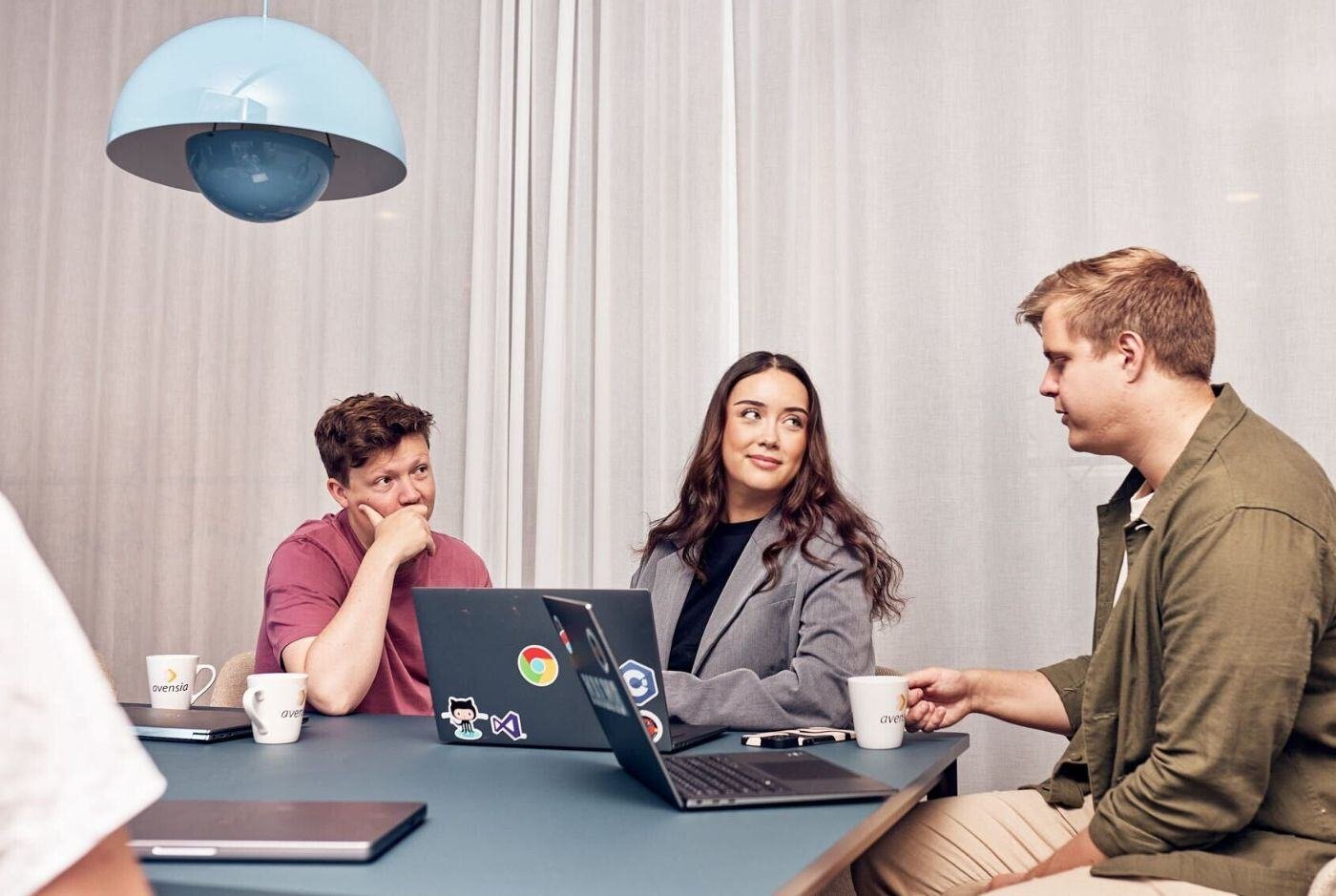 Three colleagues sitting in a meeting room