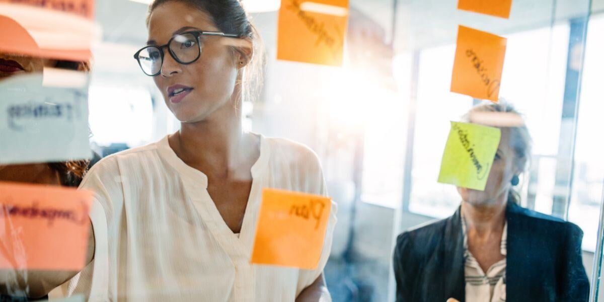 Two women brainstorming with post it notes