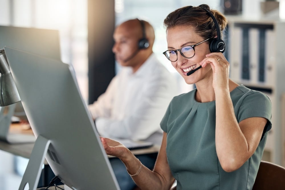 A woman wearing a headset working in customer service